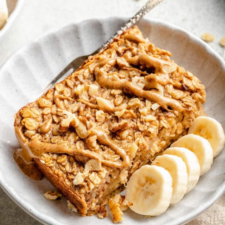Banana pumpkin baked oatmeal with Greek yogurt in a white baking dish